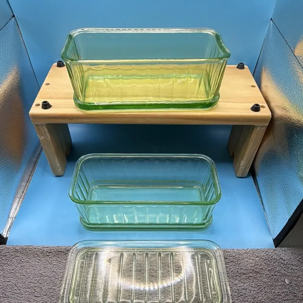 Uranium depression glass refrigerator dishes from the 30’s glows green. One lid.